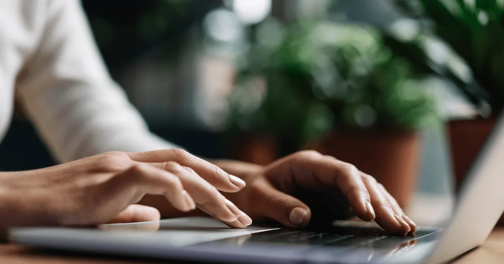 A close-up of hands on a keyboard