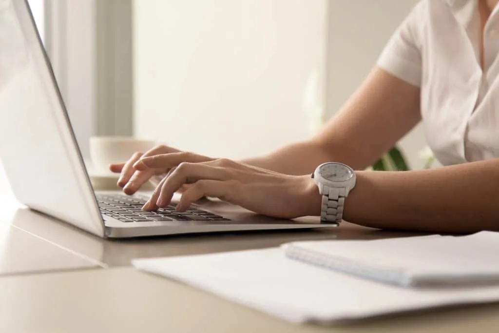 Woman working on laptop.