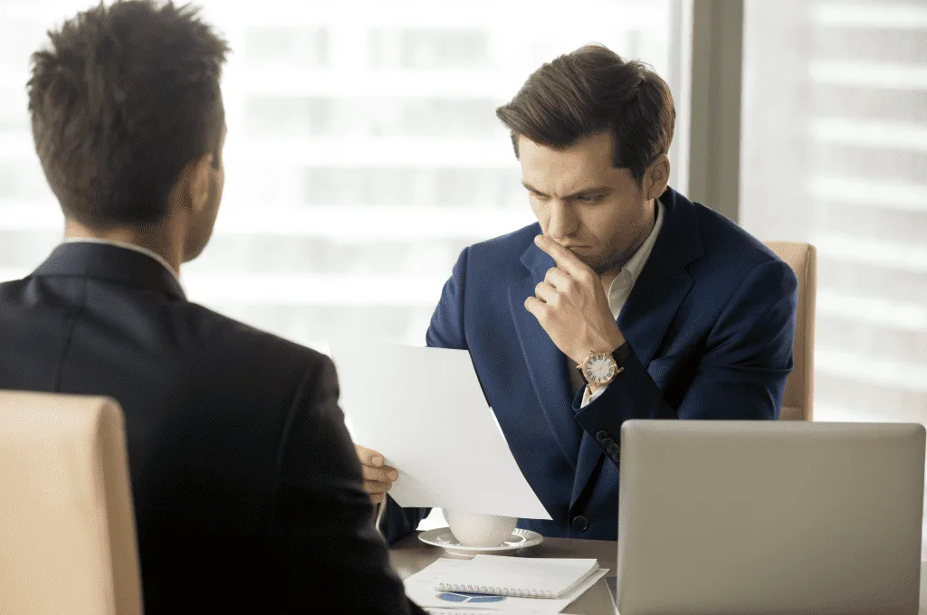 An HR manager carefully examining the candidate's resume