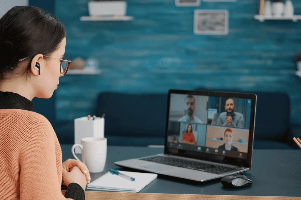 An individual attenting an online call with a group of people