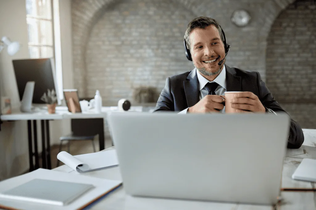 An Individual Having an Video Conference While Working Office Drinking Coffee