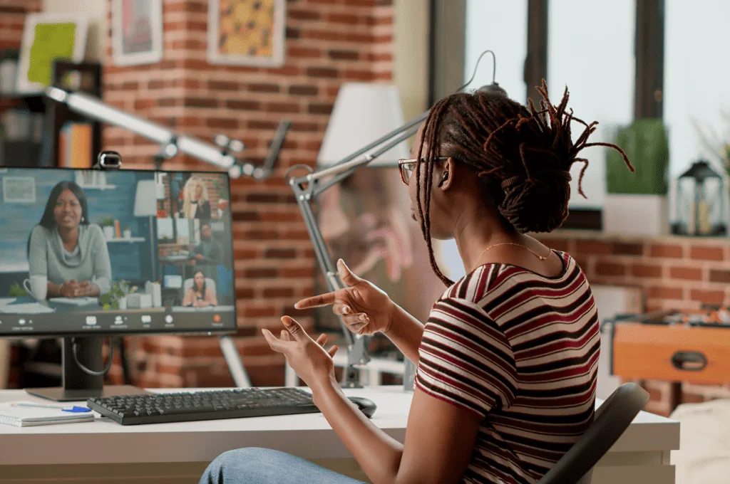 Company employee attending video call business meeting computer with webcam talking to colleagues