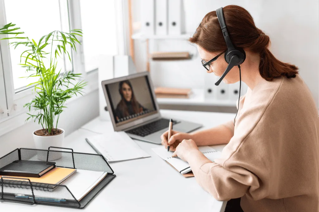 Woman Noting Something While Having an Online Meeting