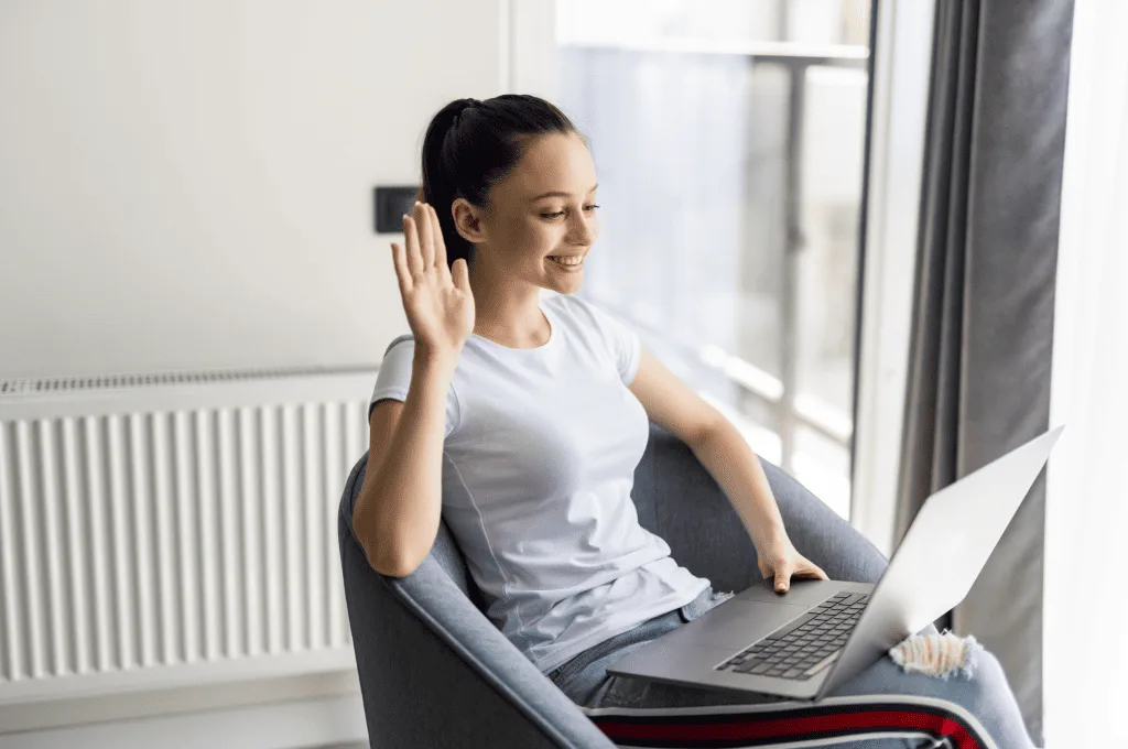 young-woman-waving-hand-on-a-videocall