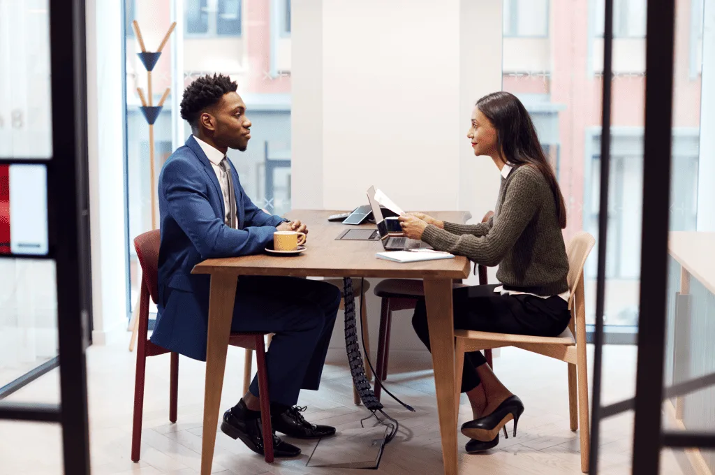 Businesswoman interviewing a male job candidate in a meeting room