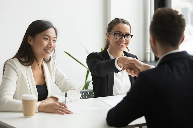 An image of an HR professional and an applicant engaging in an interview, representing the hiring process and job application experience.
