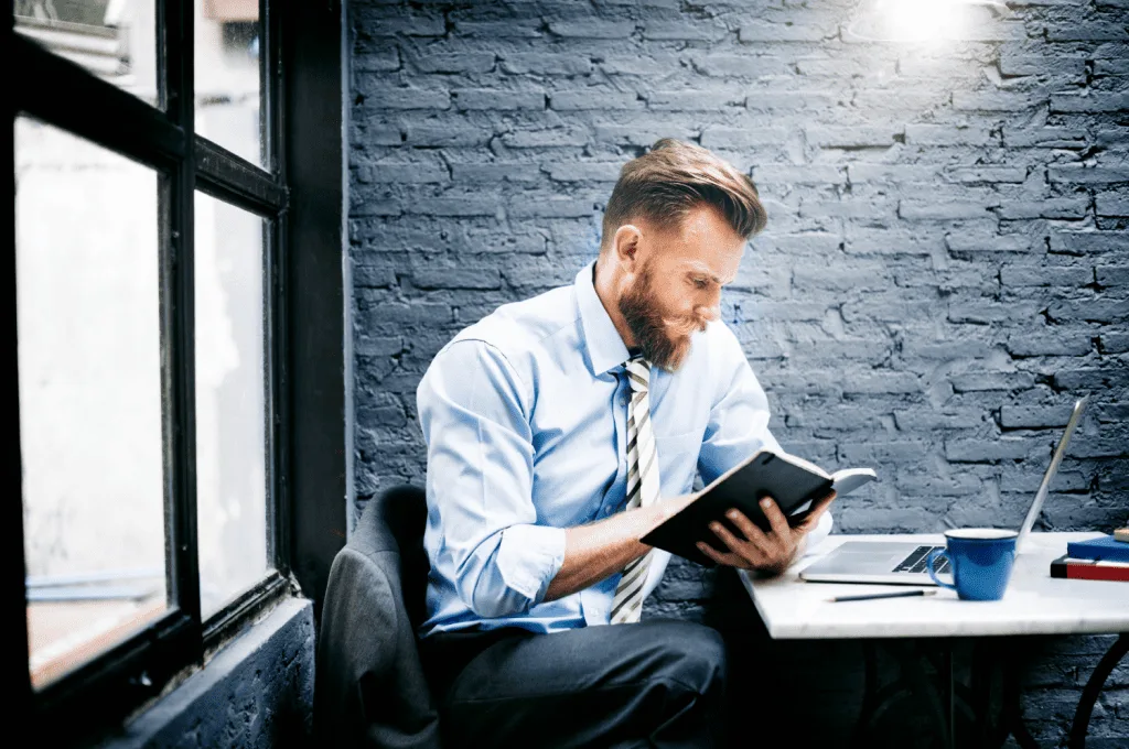 HR manager reading unique book about HR techniques
