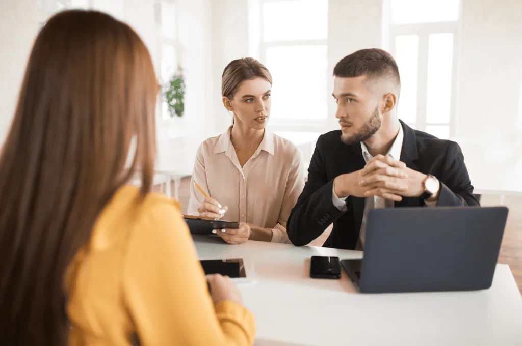 Recruiters Speaking To Candidate and Filling Survey in Hiring Process